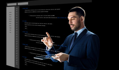 businessman with tablet pc and virtual coding
