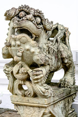 Chinese Stone Lion stand guard at a gate of Wat Pho