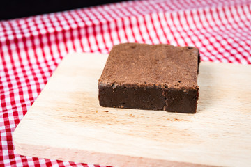 Fototapeta na wymiar Chocolate Brownie cake on a dark plate