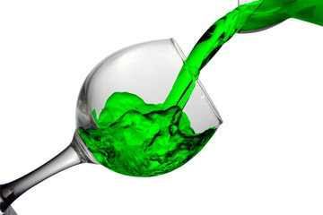 Green water pours into a glass on a white background