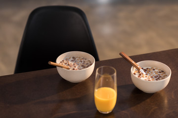 breakfast at home with orange juice and corn flakes with milk