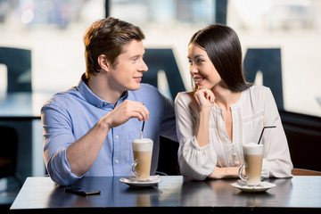 Beautiful happy young couple in love at romantic date in restaurant