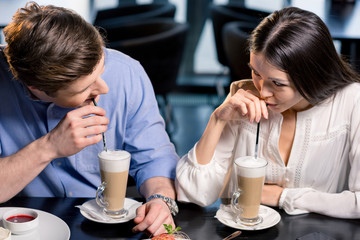 Beautiful happy young couple in love at romantic date in restaurant