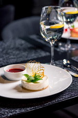 close up view of tasty dessert with glasses of water on table in restaurant