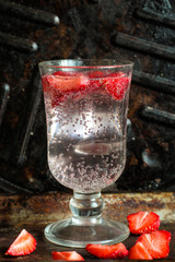  Strawberries with soda in a transparent glass