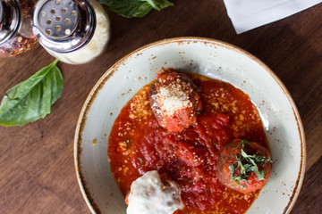 Meatball sampling with burrata mozzarella, fresh basil, and crushed red pepper