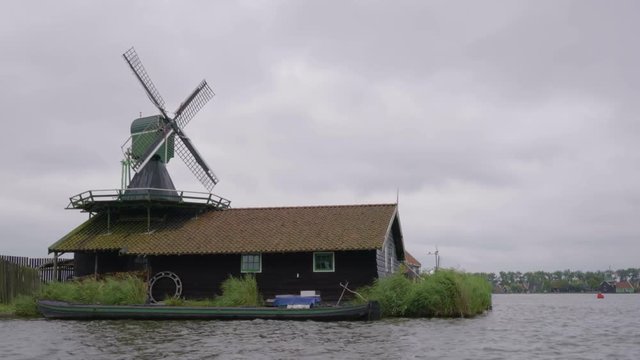 Working Windmill Spins In The Wind At UNESCO World Heritage Site, Kinderdijk, Netherlands