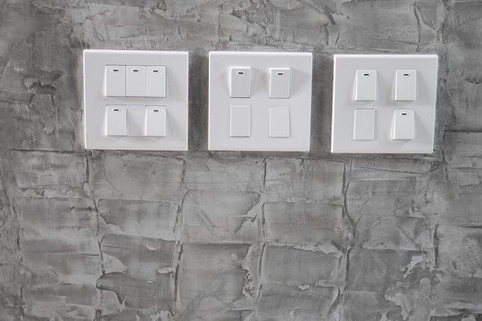 White plastic switch panel on loft style wall