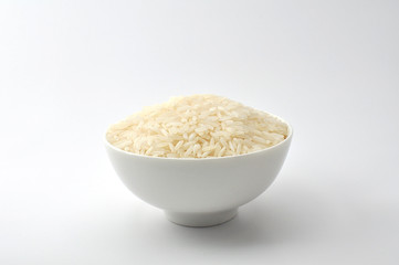 Uncooked rice, jasmine rice, mali rice,Thai jasmine rice in a wood ladle on white background.