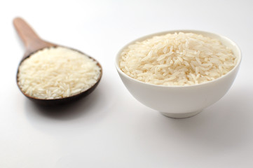 Uncooked rice, jasmine rice, mali rice,Thai jasmine rice in a wood ladle on white background.