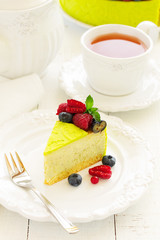 Home pistachio cheesecake with raspberries and blueberries.