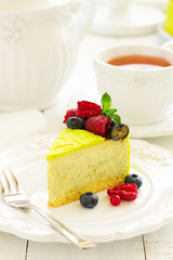 Home pistachio cheesecake with raspberries and blueberries.