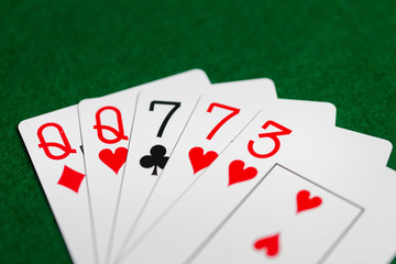 poker hand of playing cards on green casino cloth