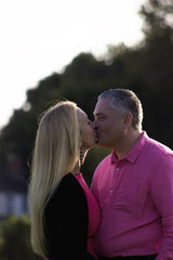 Middle aged couple kissing outside