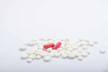  two red pills medicine on white pills background