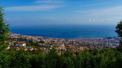 Naklejka na ściany i meble Madeira - View down to the harbor of Funchal with blue water from mountain village monte