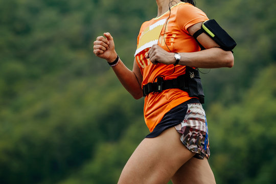 Running Girl Athlete On Hand Watch And Smartphone Is Case