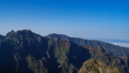 Madeira - Pico do Arieiro mountains with green rocks and clouds beneath