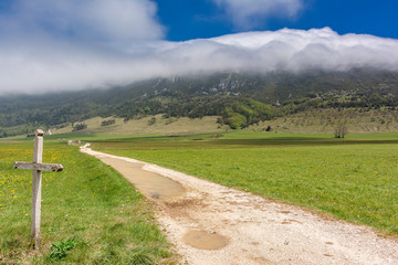 French countryside. Landscape on the plateau of Vercors with cloud formation in the mountains.