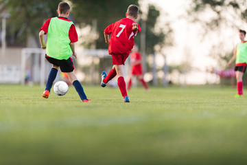 Kids soccer football - children players match on soccer field