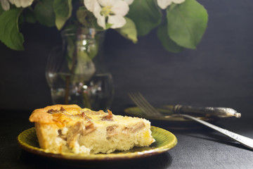 Quiche with Turkey. Homemade rustic pie on a black background.