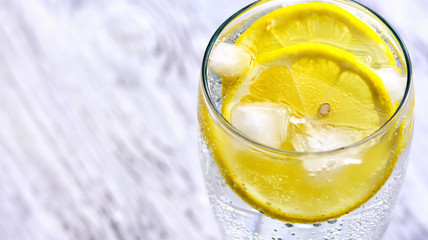 Cold mineral water with ice and lemon.