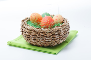 Easter colored chicken eggs which a rabbit brought in a wooden basket