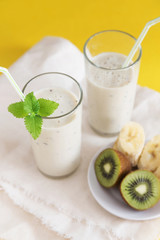Smoothie in glasses with milk and kiwi