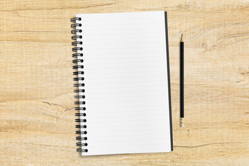 Blank notebook page with pencil are on top of wood table, top view, flat lay.