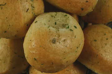 Homemade buns with garlic and dill on wooden table