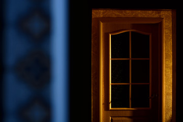 A wooden door in a dark apartment. Horror. Minimalism.