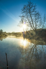 Fototapeta premium Morning mist on the river in spring, sunrise