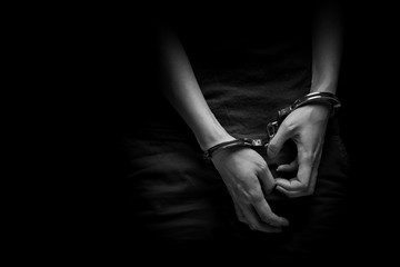 concept human trafficking,hand girl in shackle on isolate black background