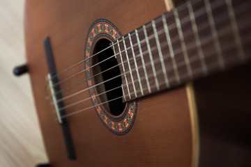Fototapeta premium detail of classic guitar with shallow depth of field