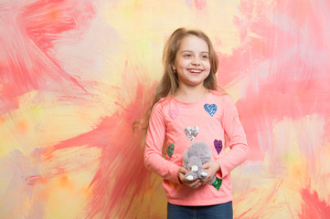 girl, happy small child with curly hair, rabbit toy