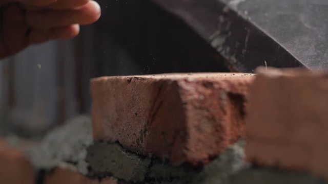 Strong man's hands building a house