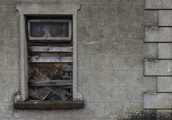 Boarded-up window of an old abandoned  building.
