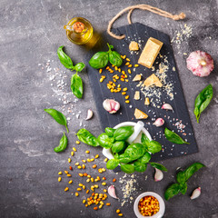 Pesto ingredients for Preparing Sauce in mortar  Background with a space for a text.Green Basil,Pine Nuts,Garlic,Olive oil,Parmesan Cheese.selective focus.