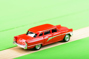 Red vintage car model on wooden boards