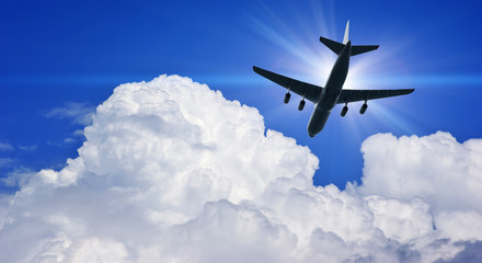 Fototapeta na wymiar Airplane silhouette in deep blue sky.