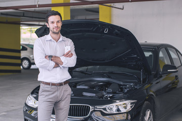 Male model waiting besides a car