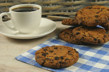 Coffee cup with oatmeal cookie chocolate on wooden background