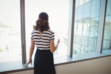 Thoughtful executive standing near window