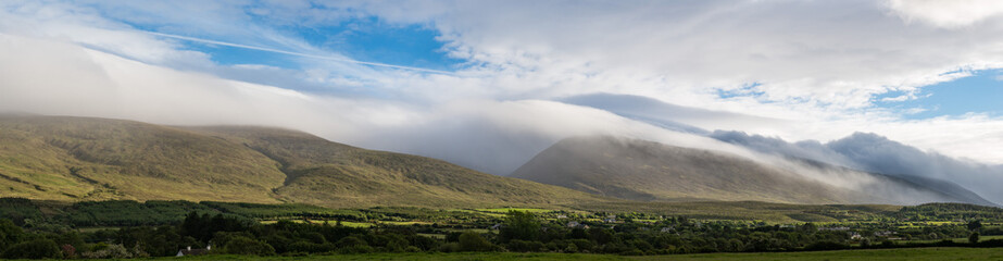 Obraz na płótnie Canvas Dramatic sky storm clouds and mist falling on the Dingle peninsula in county Kerry, Ireland