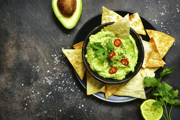 Avocado dip guacamole with tortilla chips.Top view with copy space. - obrazy, fototapety, plakaty