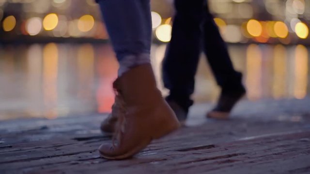 Closeup Of Couple's Feet As They Dance On A Dock In The City At Night