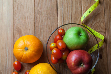 Healthy concept with mixed fruits and vegetables on wooden background