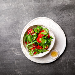  Salad with baby Spinach, arugula and Fresh Cherry Tomatoes Flax seeds and Olive oil.Food or Healthy diet concept.Super Food.Vegetarian.Top View.Copy space for Text. selective focus.