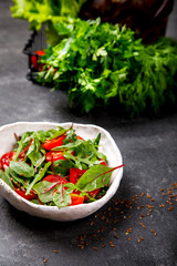  Salad with baby Spinach, arugula and Fresh Cherry Tomatoes Flax seeds and Olive oil.Food or Healthy diet concept.Super Food.Vegetarian.Copy space for Text. selective focus.