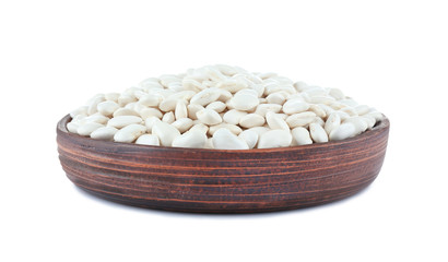 Plate with butter beans on white background